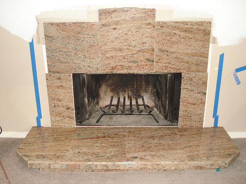 Granite tiles surround remodeled fireplace